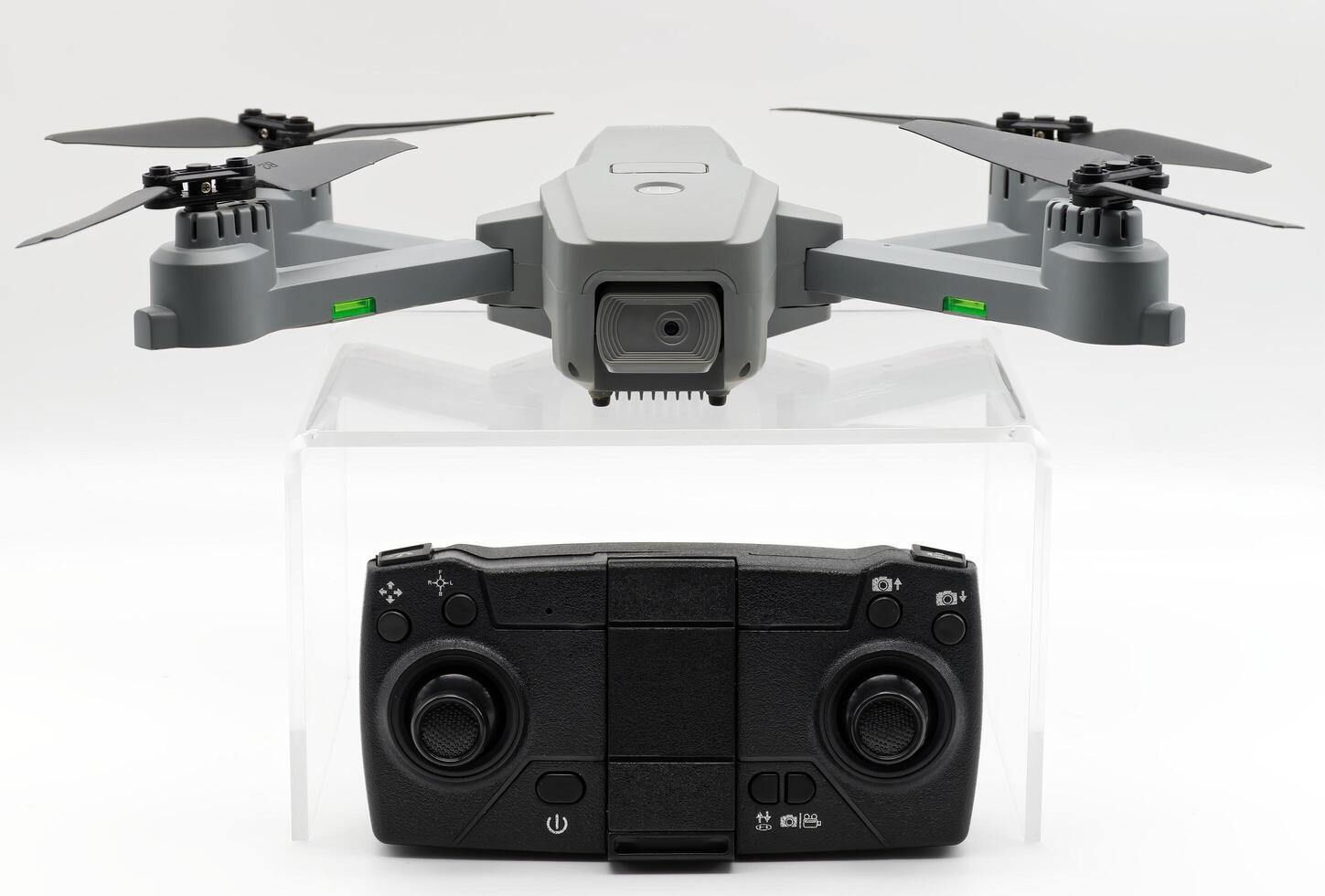 Gray drone and remote control isolated on white background. photo