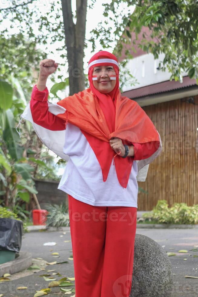 Indonesian independence day spirit portrait of woman with flag face paint photo