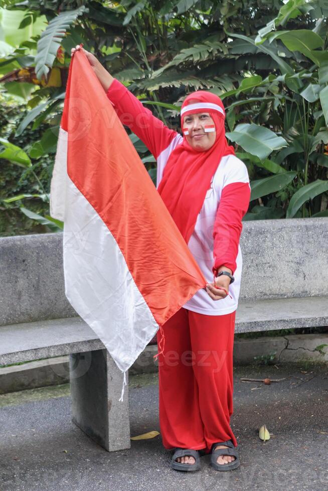 Independence Day spirit with national flag waving by cheerful woman photo