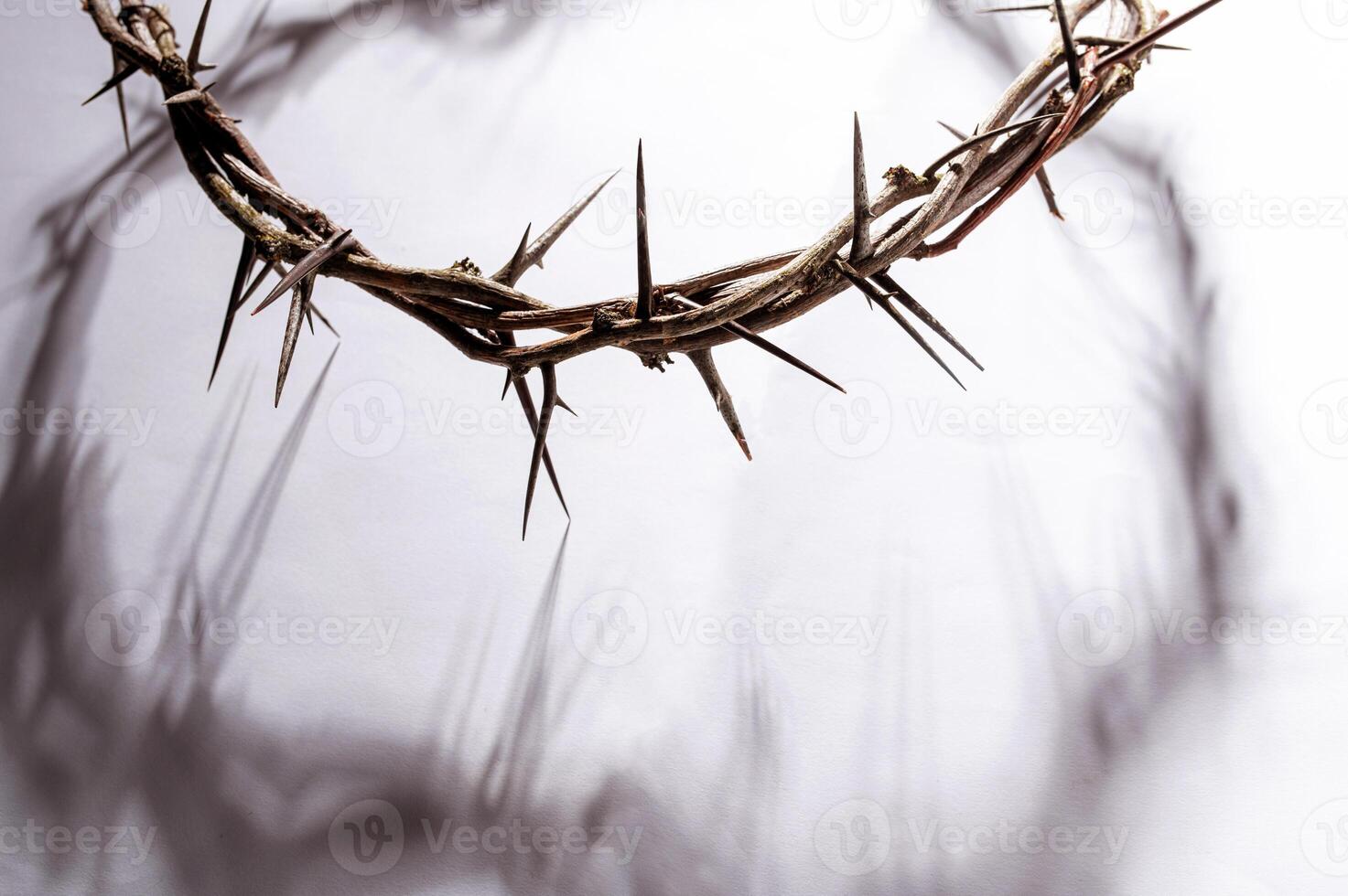 Crown of thorns casting a distinct shadow on a white background, creating a symbolic easter image of suffering, sacrifice, remembrance Copy space for text good friday photo