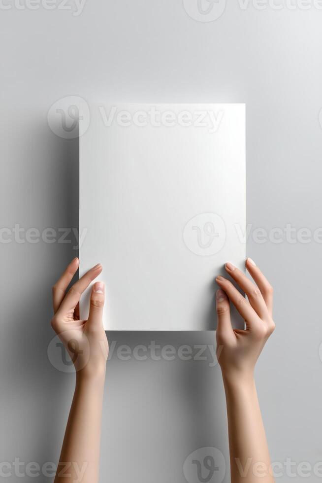 poster mockup featuring a blank white vertical sheet held up by two hands against withe background photo
