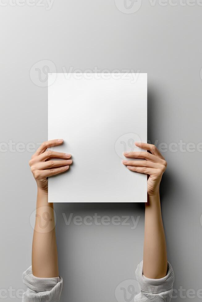 poster mockup with a blank white vertical sheet held up by two hands against withe background photo