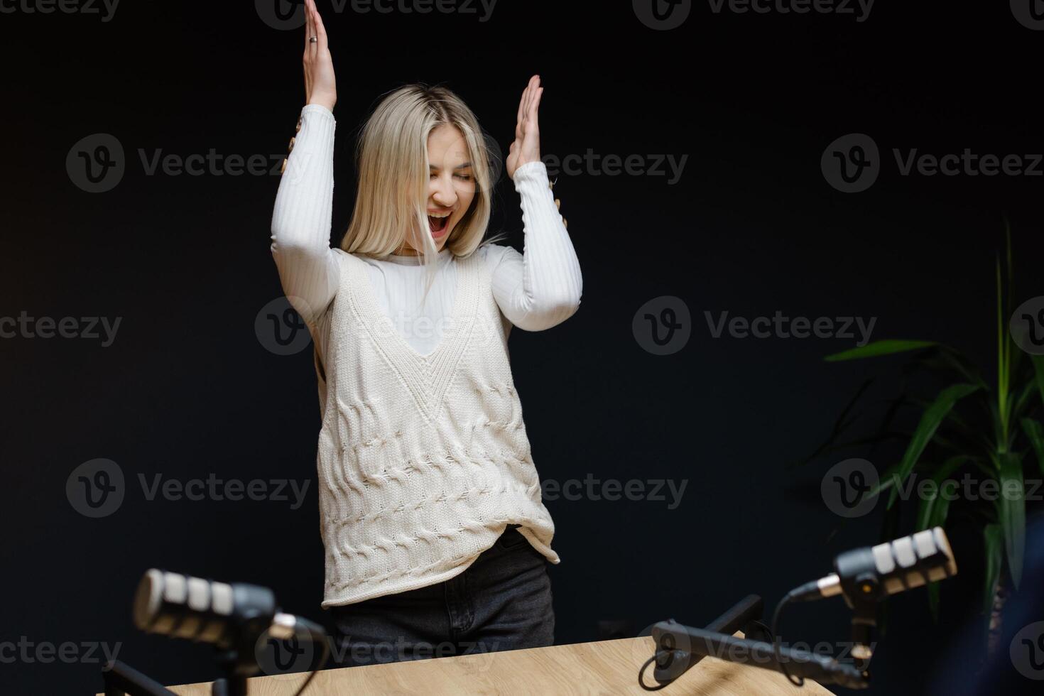 Podcaster dancing and laughing during a recording session photo