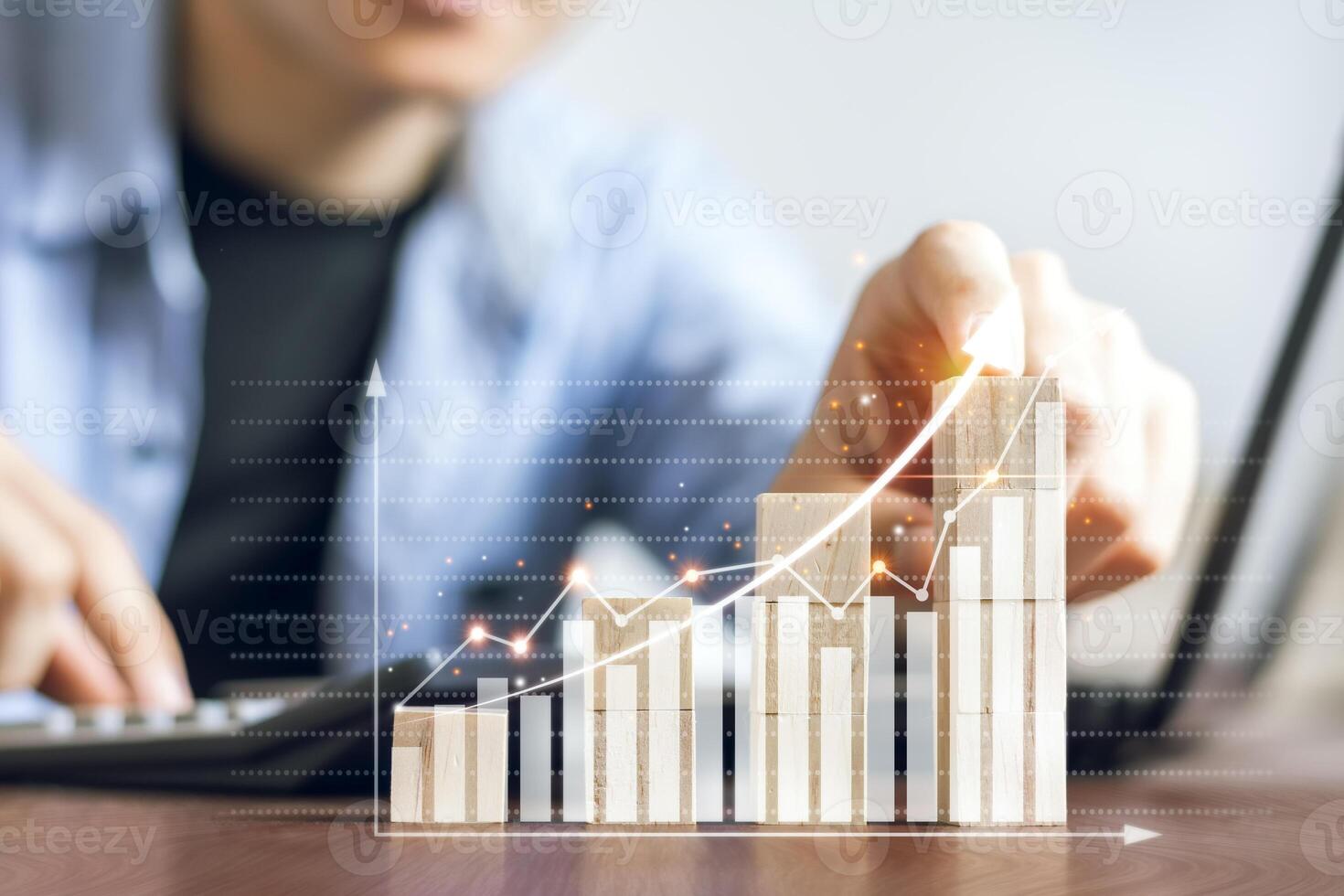 Business man using his finger to touch a business graph showing up in a virtual screen. the plans to increase business growth and an increase in the indicators of positive growth. photo
