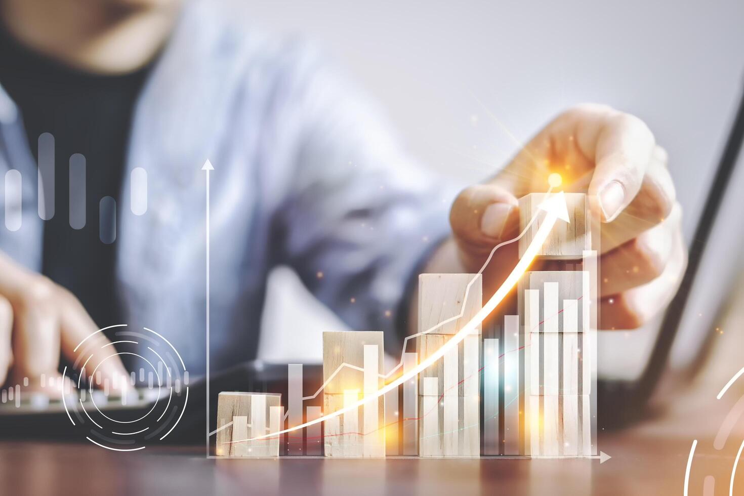 Businessmen use the finger to touch the wooden block that shows the business graph shown in the virtual screen. Plans to increase business and business growth Arrow the direction of growth and success photo
