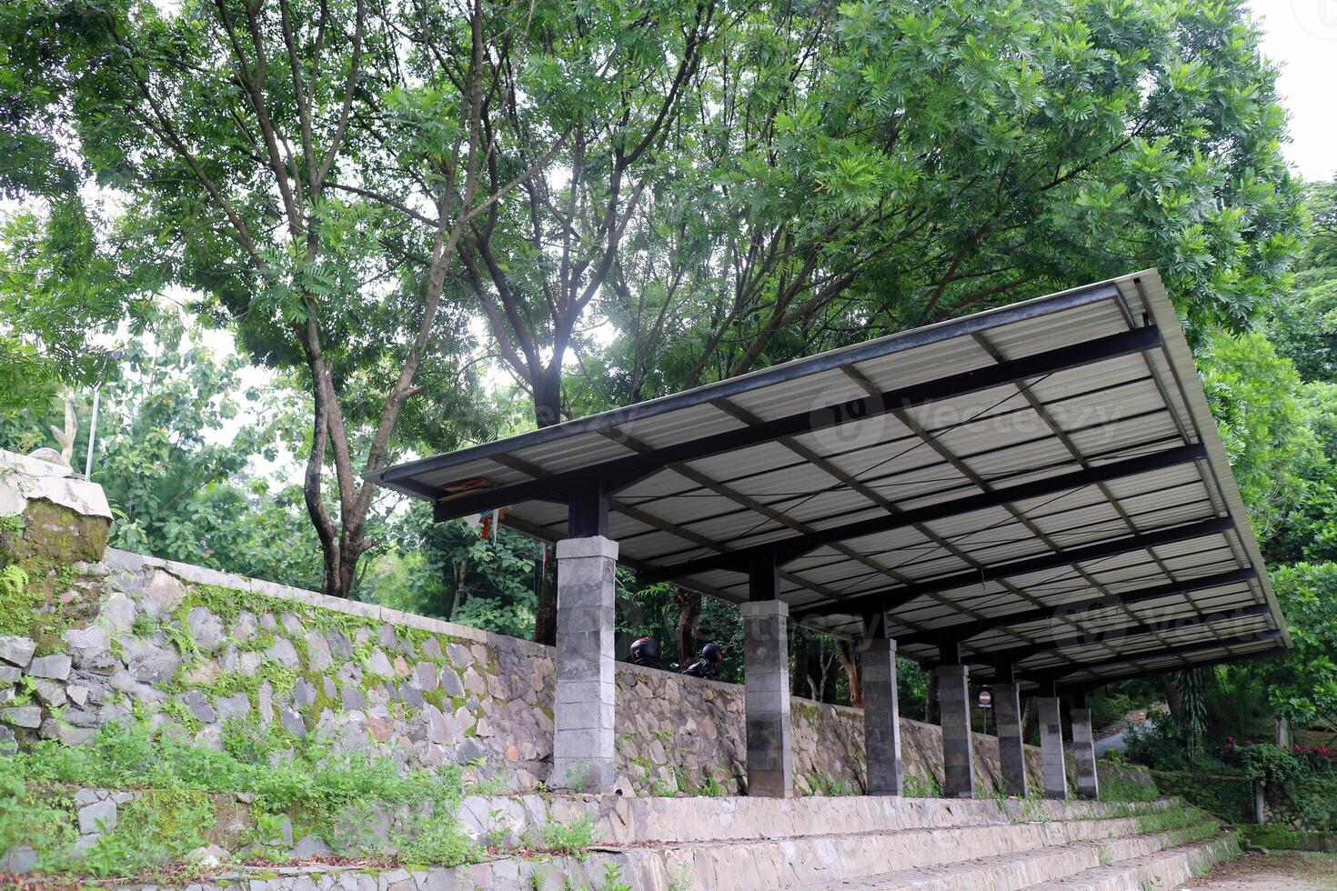Outdoor Seating Area with Roof in Green Forest Park photo