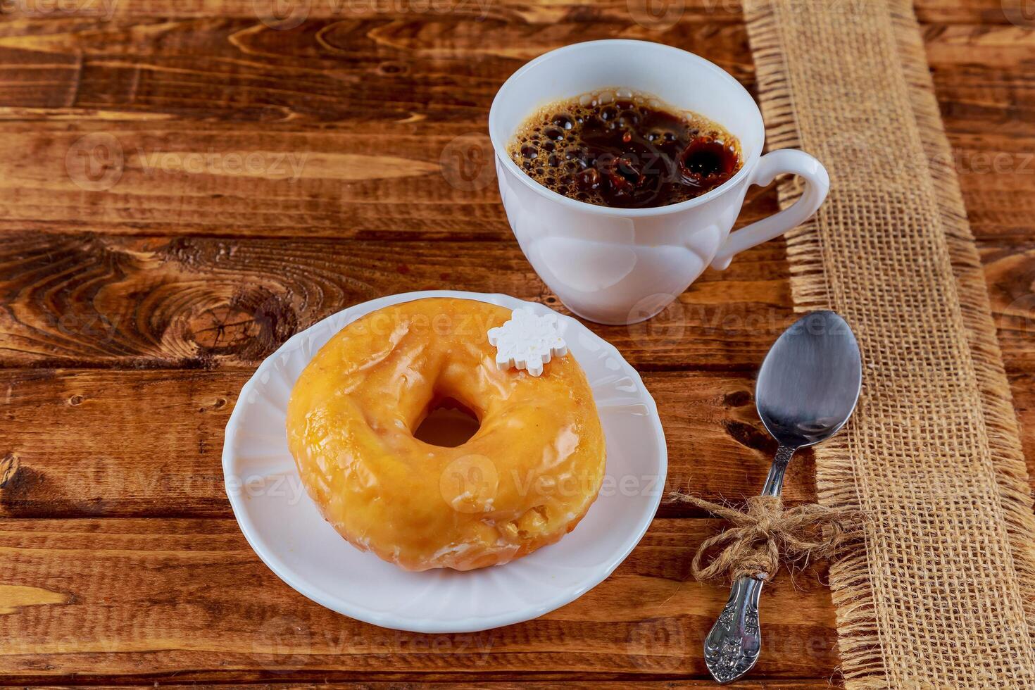 Colorful Donuts breakfast composition with different color styles of doughnuts over an aged wooden desk background. photo