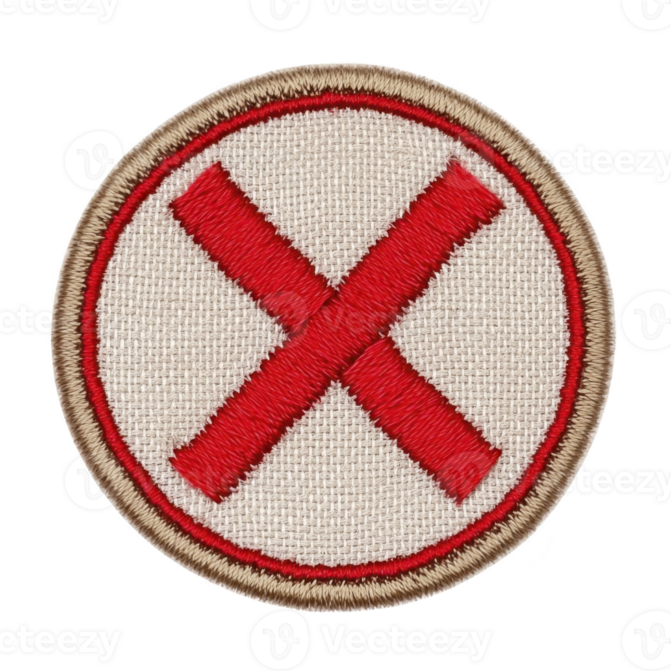 A round embroidered patch features bold red X in center, outlined with red circle and bordered by tan edge, set against beige fabric background png