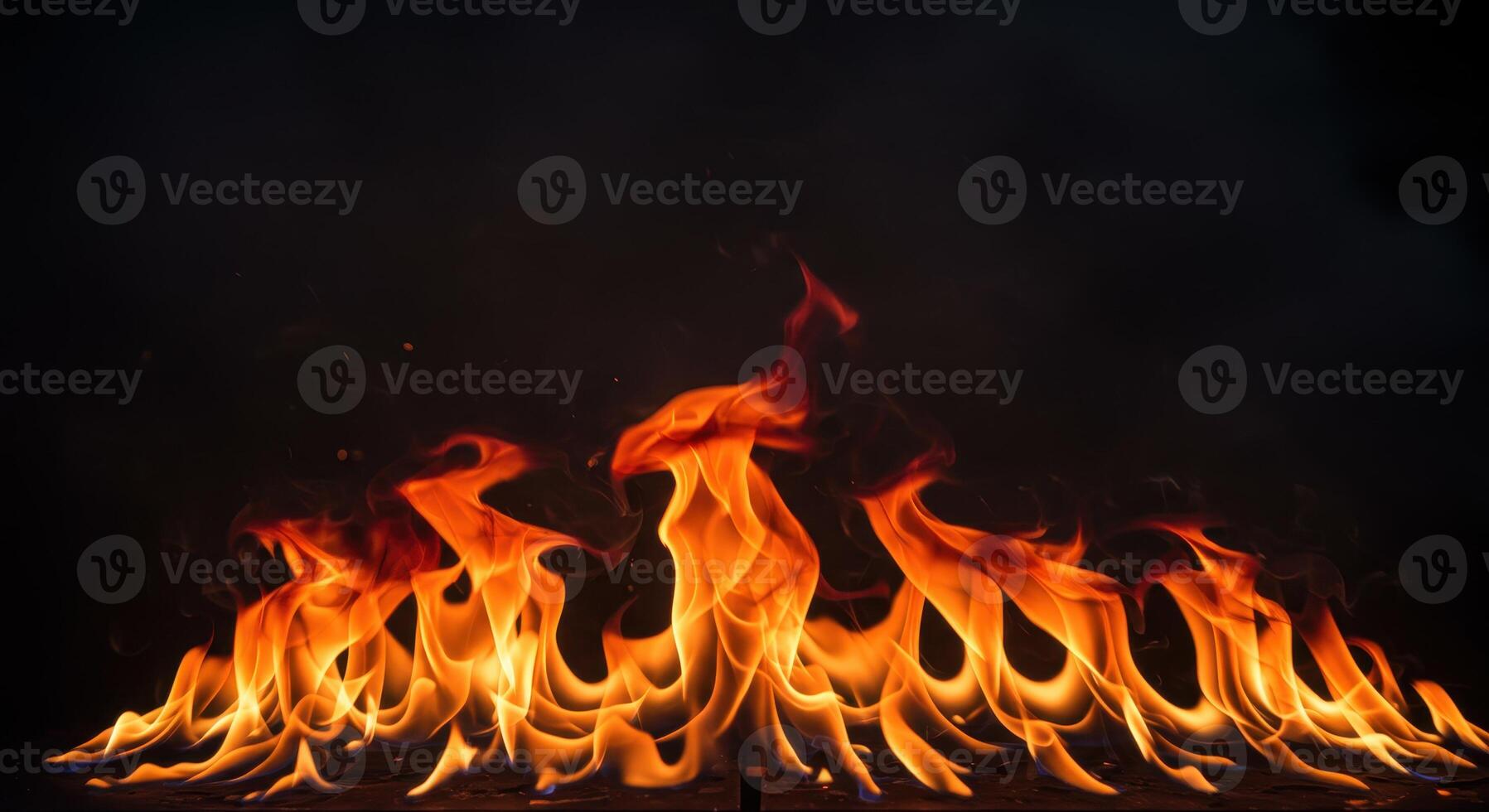 Vivid flames dance against a dark backdrop, showcasing the raw power and mesmerizing beauty of fire with intense heat and bright orange color. photo