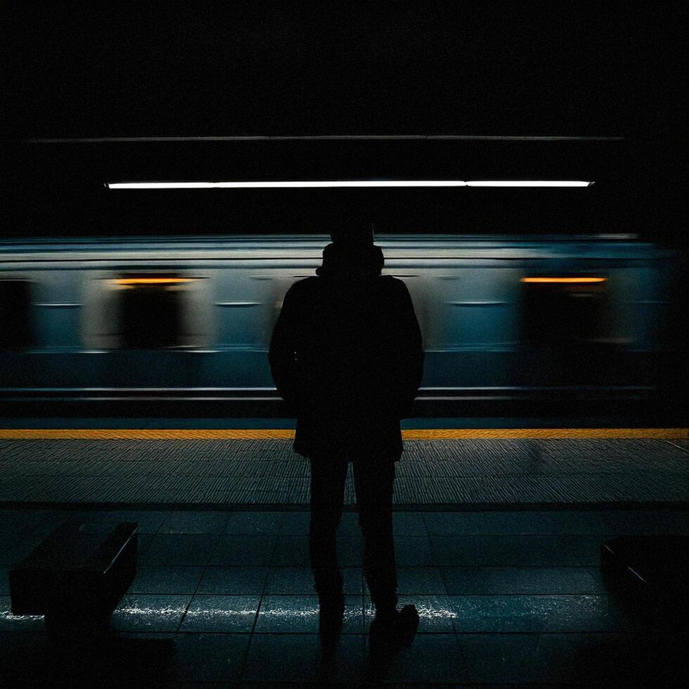 A person standing in front of a train photo