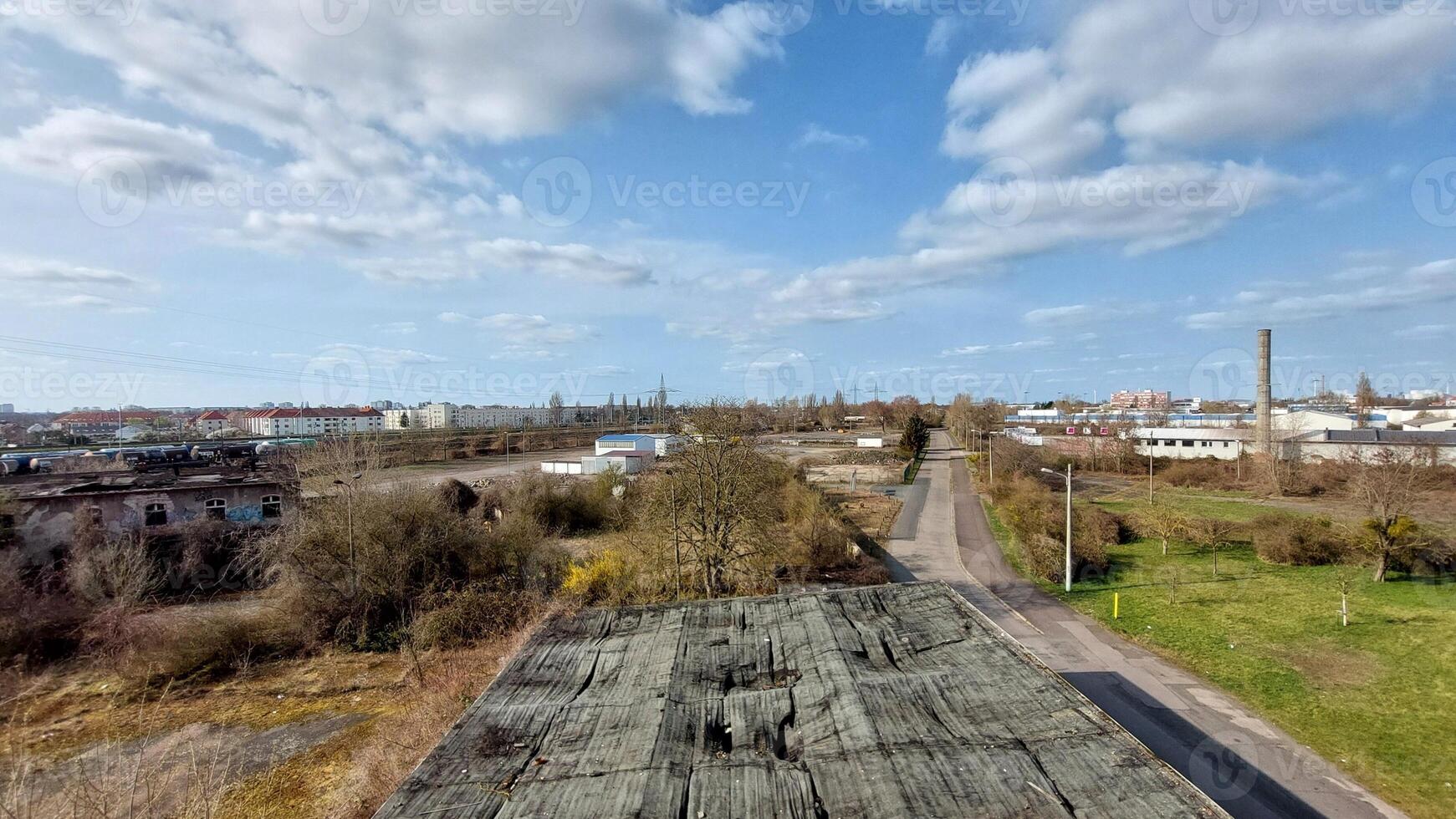 Industrial district overview in Germany with mix of urban housing, roads, and warehouse structures below photo