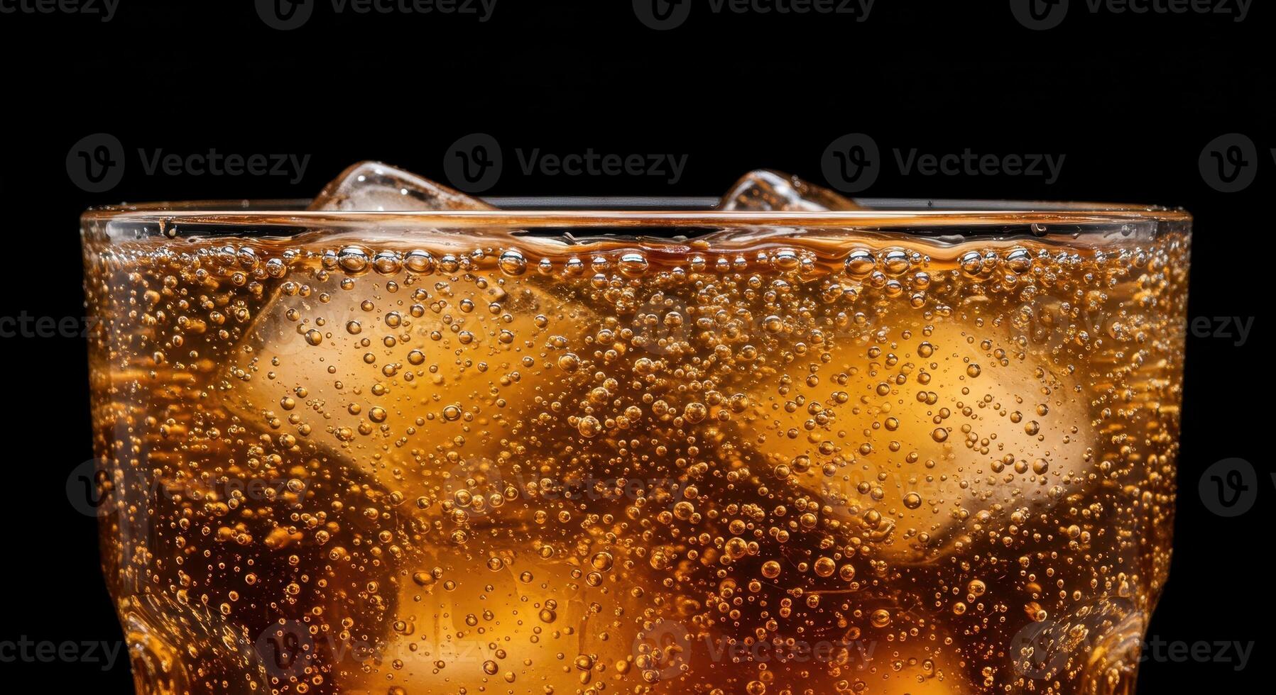 Refreshing caramel colored carbonated drink with ice cubes in a glass, showcasing effervescence and condensation against a dark background. photo