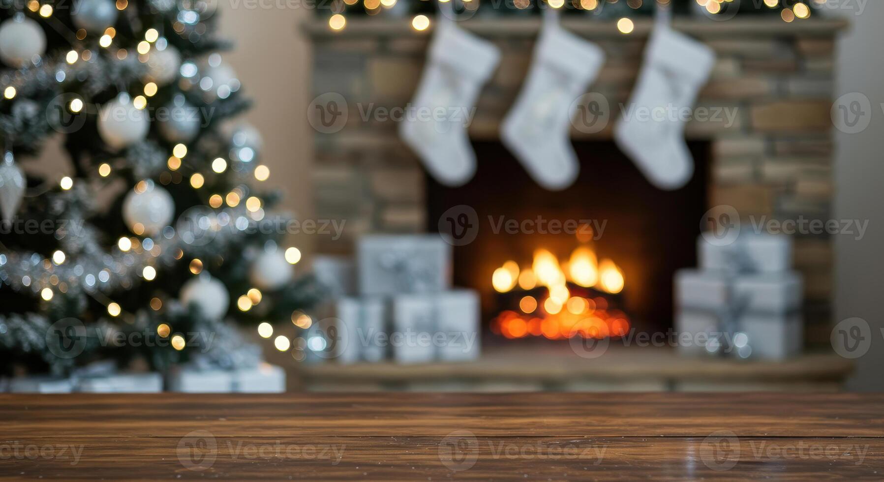Festive Christmas scene with silver ornaments on a wooden table, blurred Christmas tree, and fireplace with stockings in the background. photo
