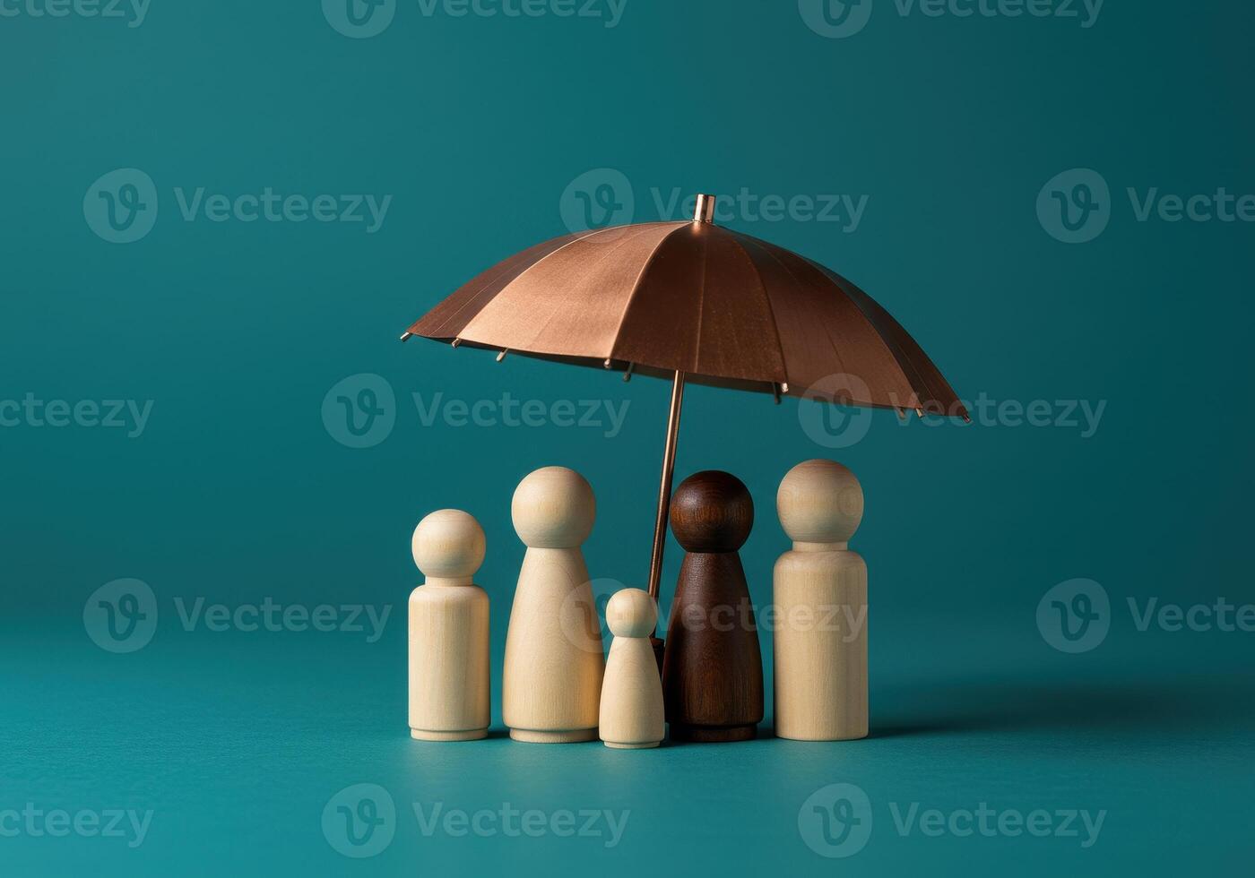 Family of wooden figures under umbrella on green background. Concept for protection, safety, security, assurance, diversity, health, life, and home insurance. photo