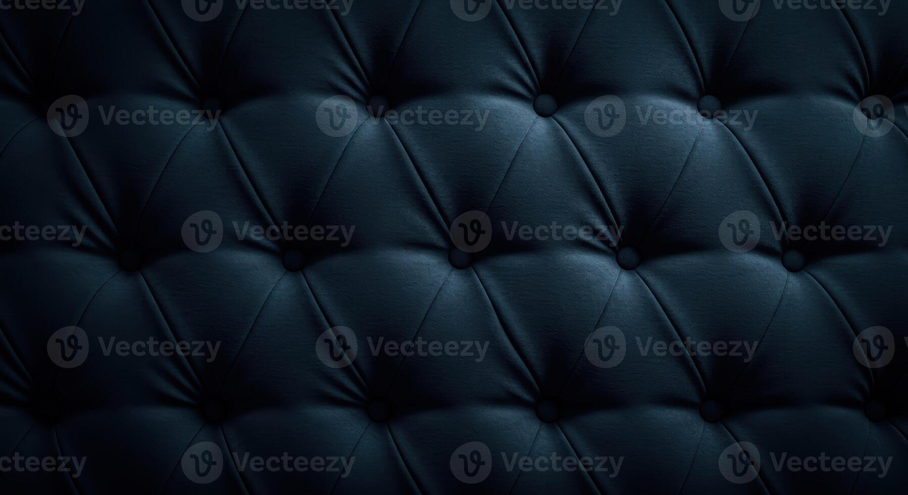 Close up of dark blue tufted velvet upholstery featuring an elegant diamond pattern. The surface showcases a plush texture and smooth matte finish. photo
