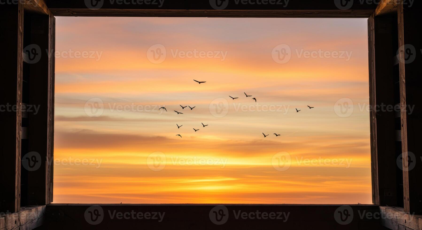 Open window framing a vibrant sunset sky with a flock of birds flying. Scenic view of nature and freedom, evoking peace and tranquility. photo