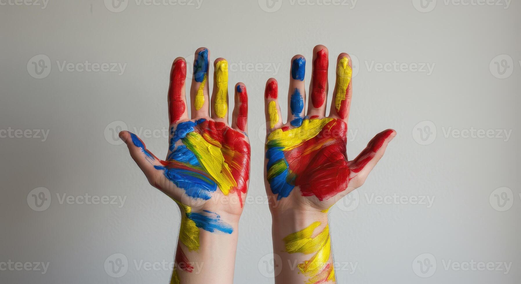 Close up of a young artist hands covered in vibrant primary color paints. Concept for creativity, art projects, childhood fun, and educational activities. photo