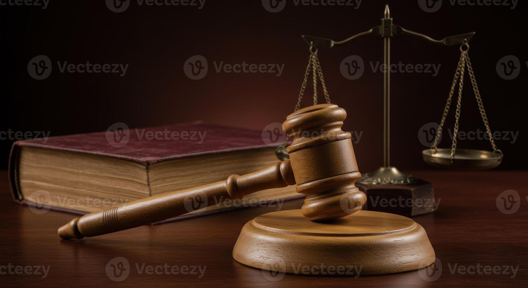 Gavel rests on sounding block, with scales of justice and law book in background. Symbolizes legal system, courtroom proceedings, and jurisprudence. photo