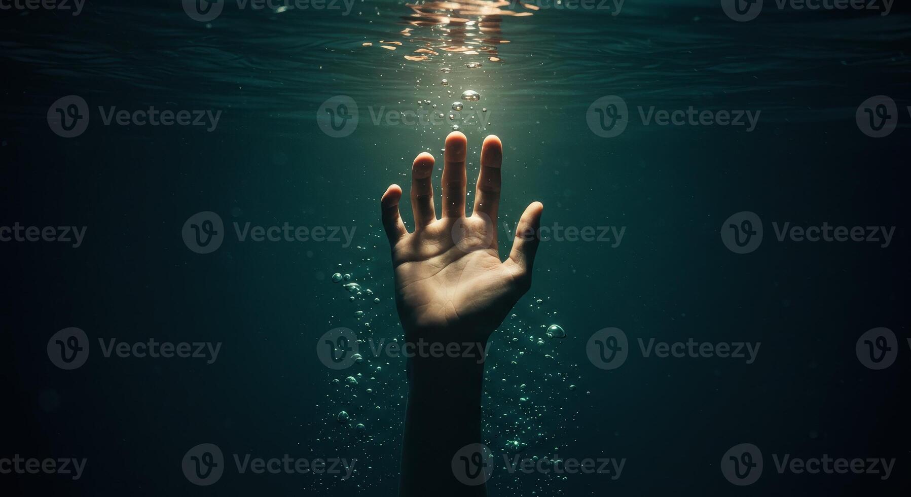 Mans hand reaching up from dark water with bubbles toward a light source, symbolizing hope, rescue, or struggle in an underwater environment. photo