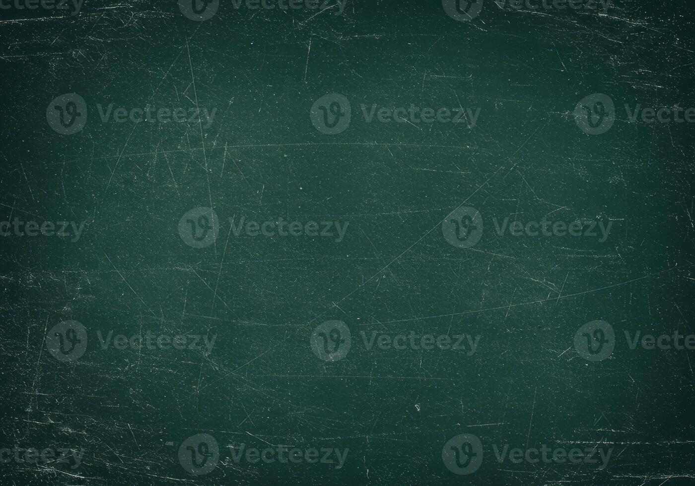 Dark green chalkboard surface with scratches. Texture of a school board with grunge effect. Abstract background with traces of chalk and wear. photo