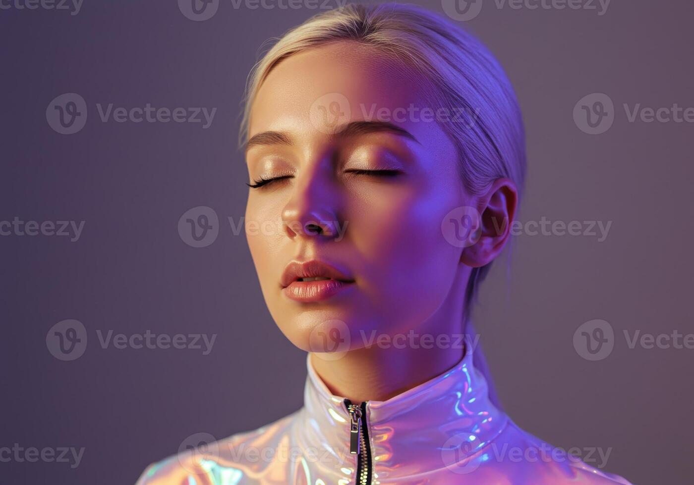 Close up studio shot of a blonde woman with closed eyes in a futuristic iridescent jacket. Beauty shot with violet and pink lighting. Fashion and science concept. photo