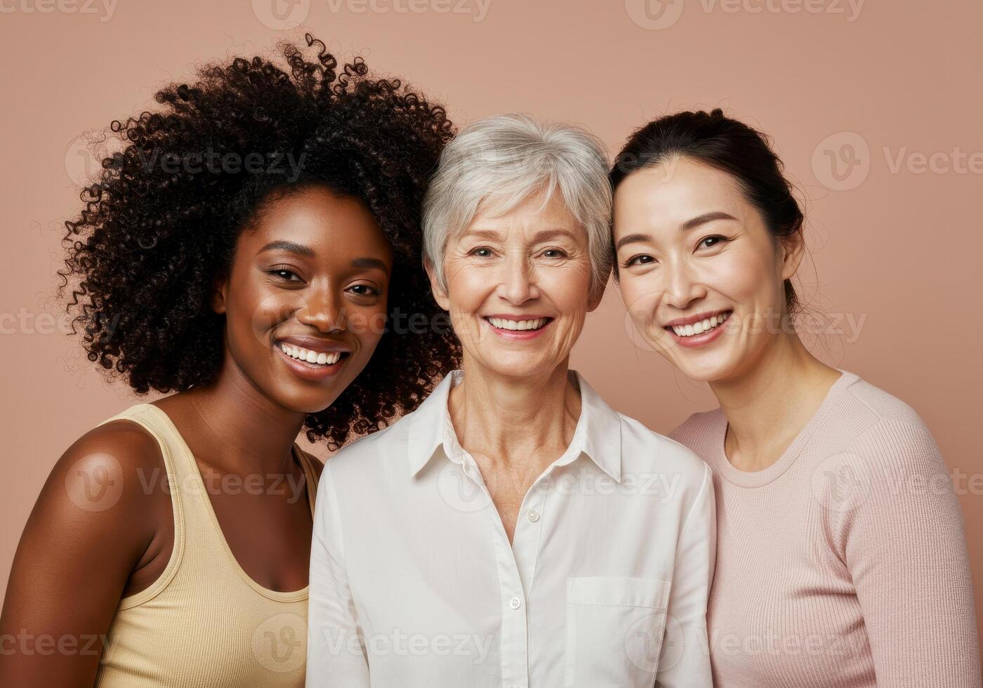 Three smiling women of diverse ethnicities and ages pose together in a beauty and skincare concept. The women showcase healthy skin and radiant smiles. photo