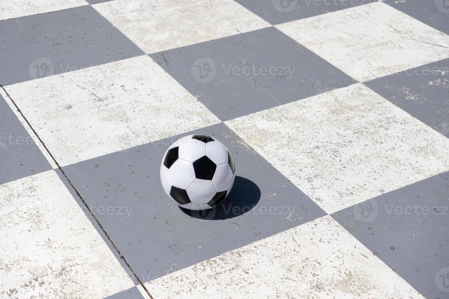 Soccer ball isolated on a gray and white checkered background photo