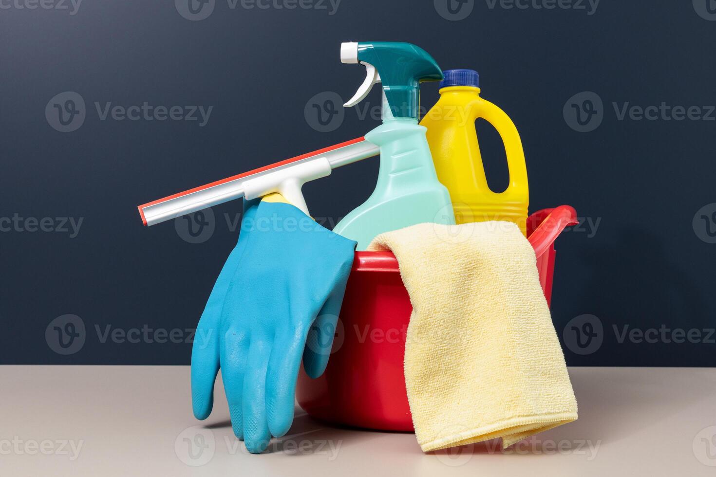 Cleaning supplies in bucket on table photo