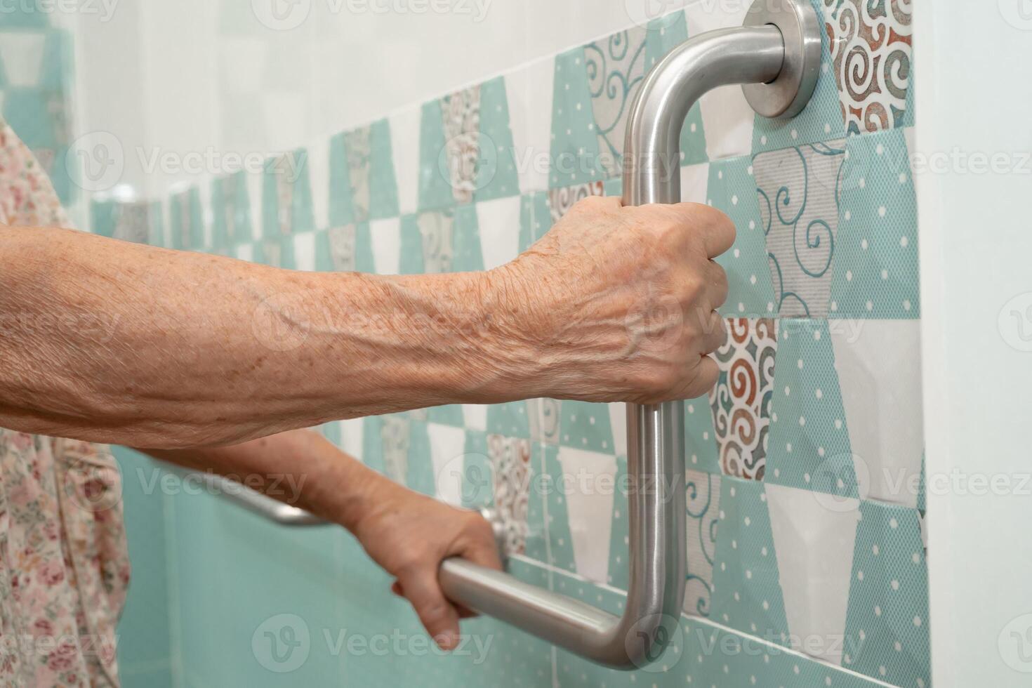 elderly woman patient use handrail safety in toilet support rail photo