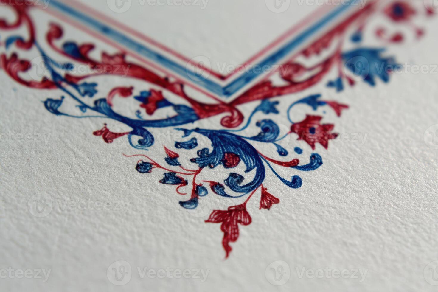 Ornate floral border in blue and red ink with intricate swirling patterns on textured paper, creating an elegant and artistic design. Emphasis on decorative details and craftsmanship photo