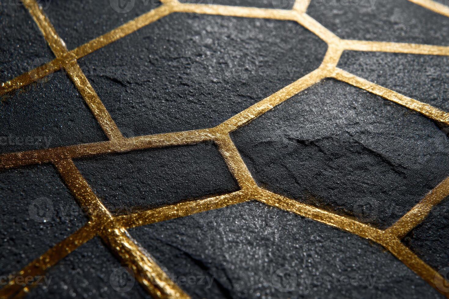 Geometric pattern with black textured stone surface intersected by metallic gold lines, forming hexagonal and polygonal shapes, creating a modern and luxurious appearance photo