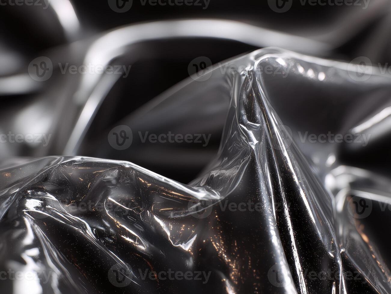 Shiny, crumpled silver material with light reflections creating an abstract and dynamic appearance, featuring smooth curves and textured highlights, evoking a sense of fluid motion photo