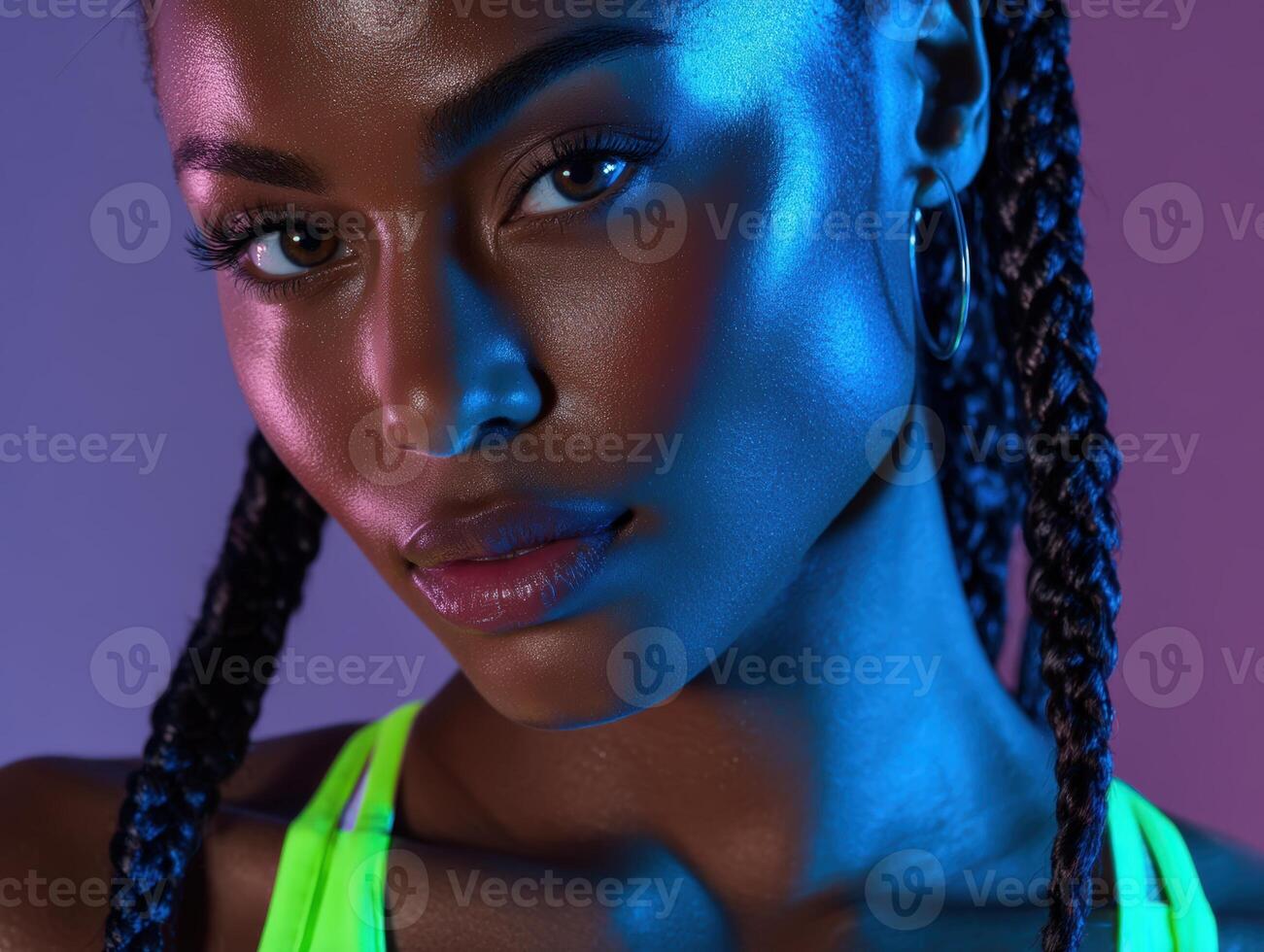 Young woman with braided hair, glowing skin, illuminated by colorful neon lights, wearing a bright green top. Her expression is confident and engaging, creating a vibrant modern vibe photo