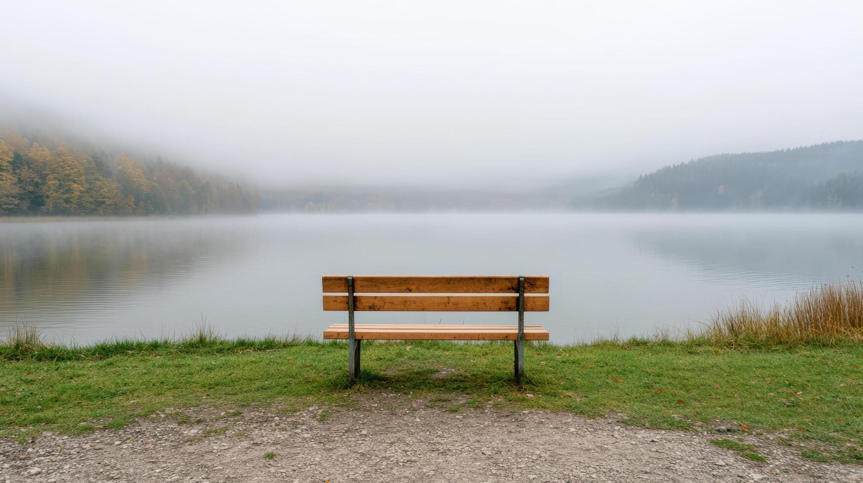 A bench sitting in front of a lake photo
