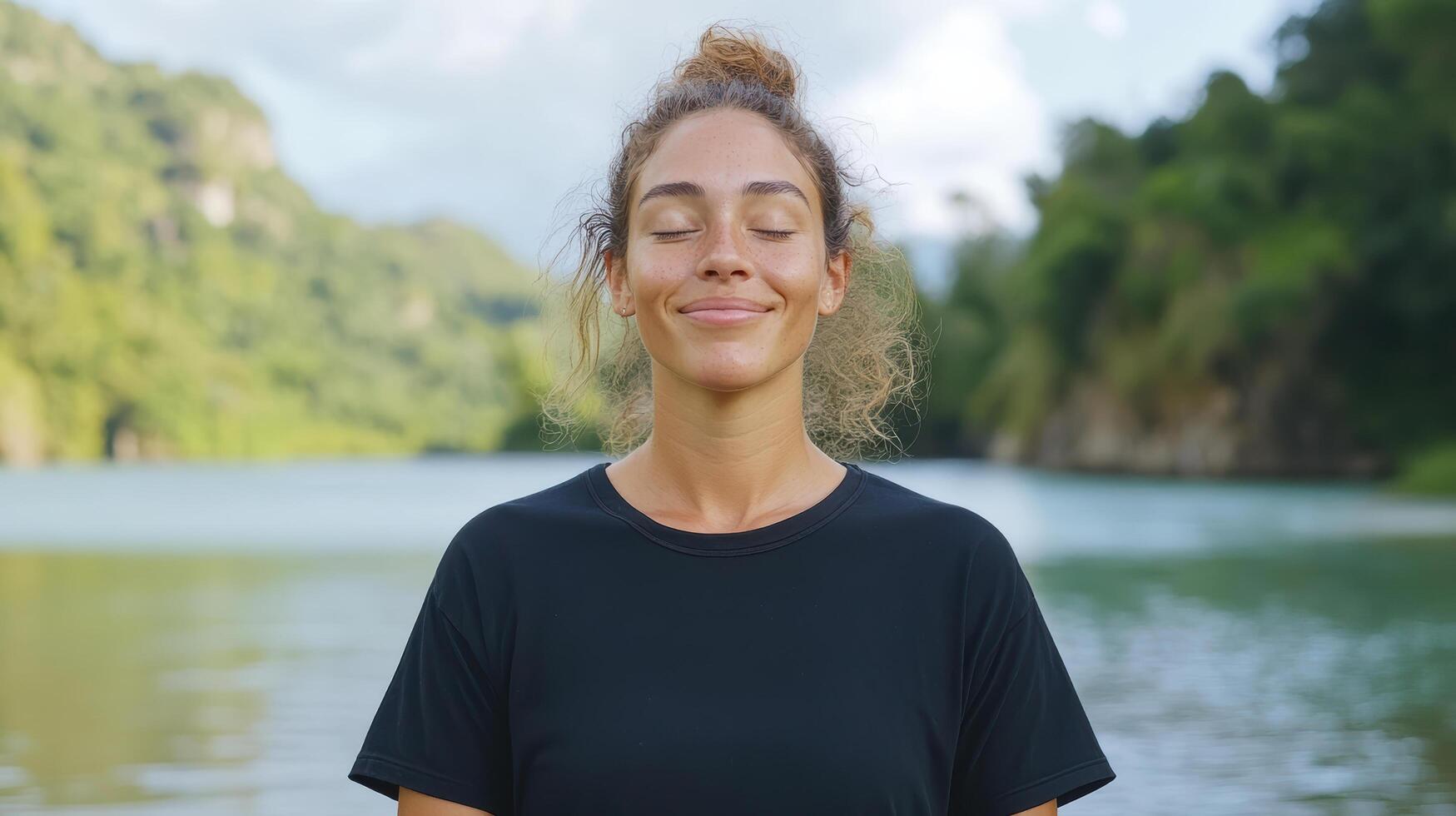 Calm woman enjoying nature with eyes closed, surrounded by serene landscape photo