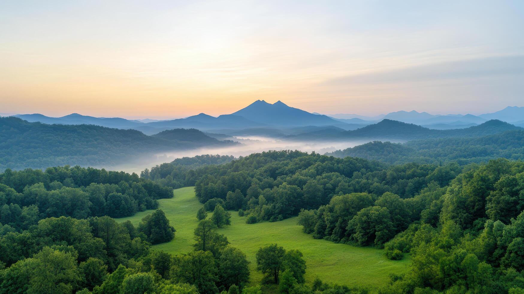 A beautiful view of a mountain range with trees and grass photo