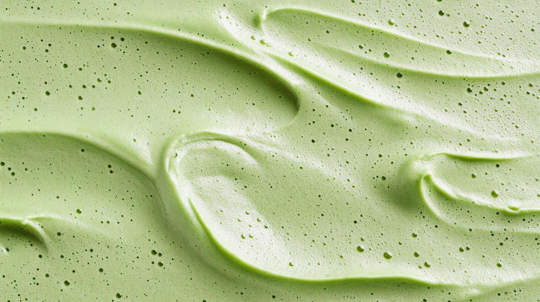 A close up of a green frosting with white swirls photo