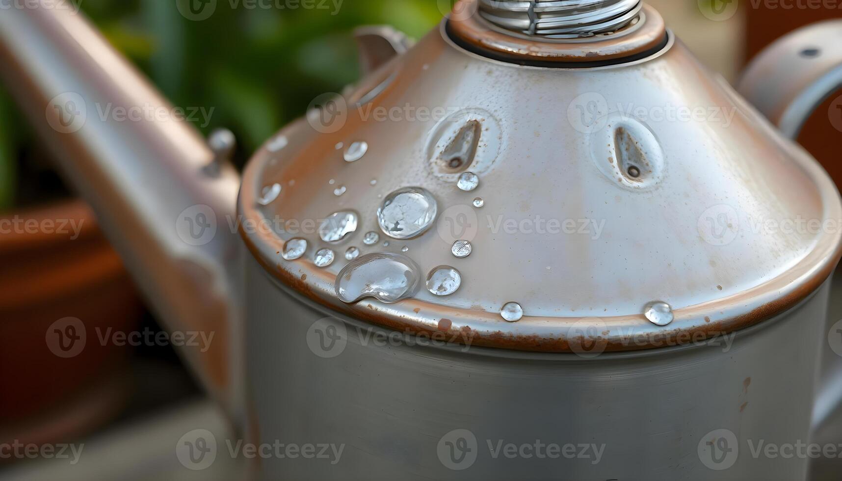 a metal tea pot with water droplets on it photo
