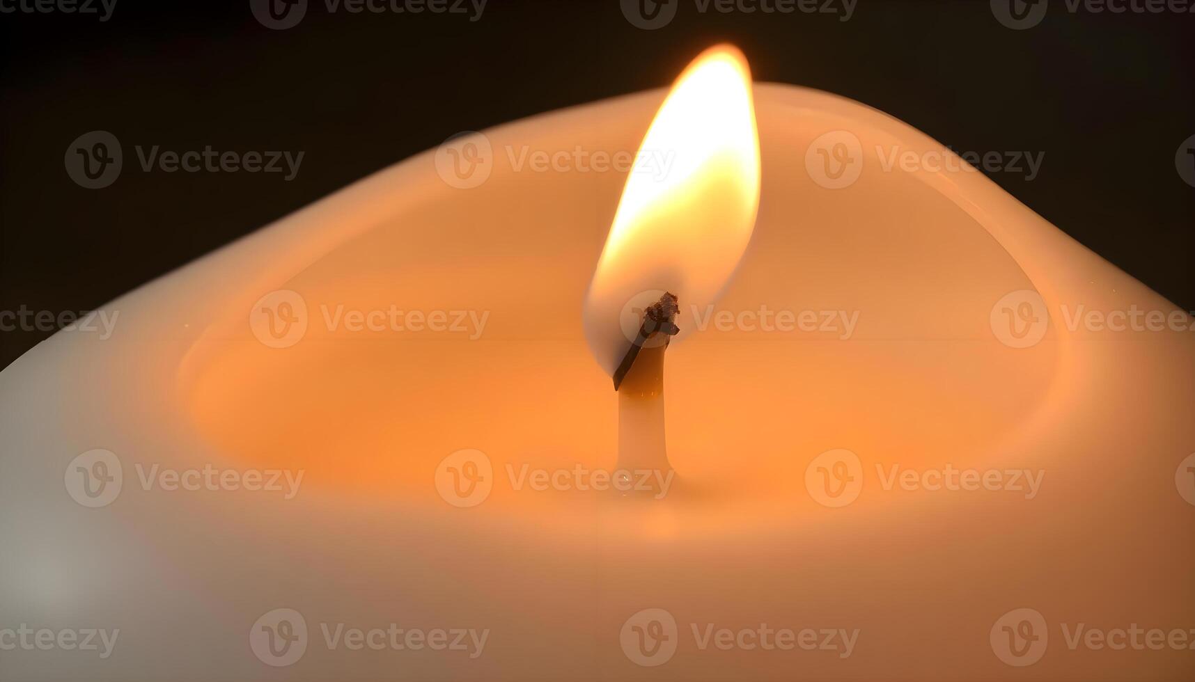 a lit candle with a single candle stick sticking out of it photo