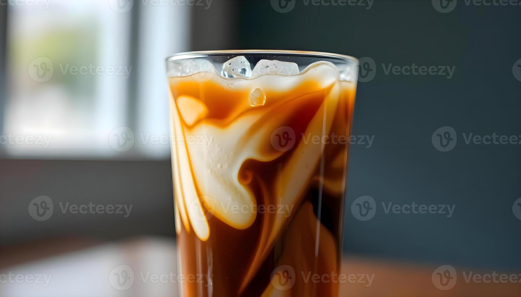 a glass of liquid sitting on top of a wooden table photo