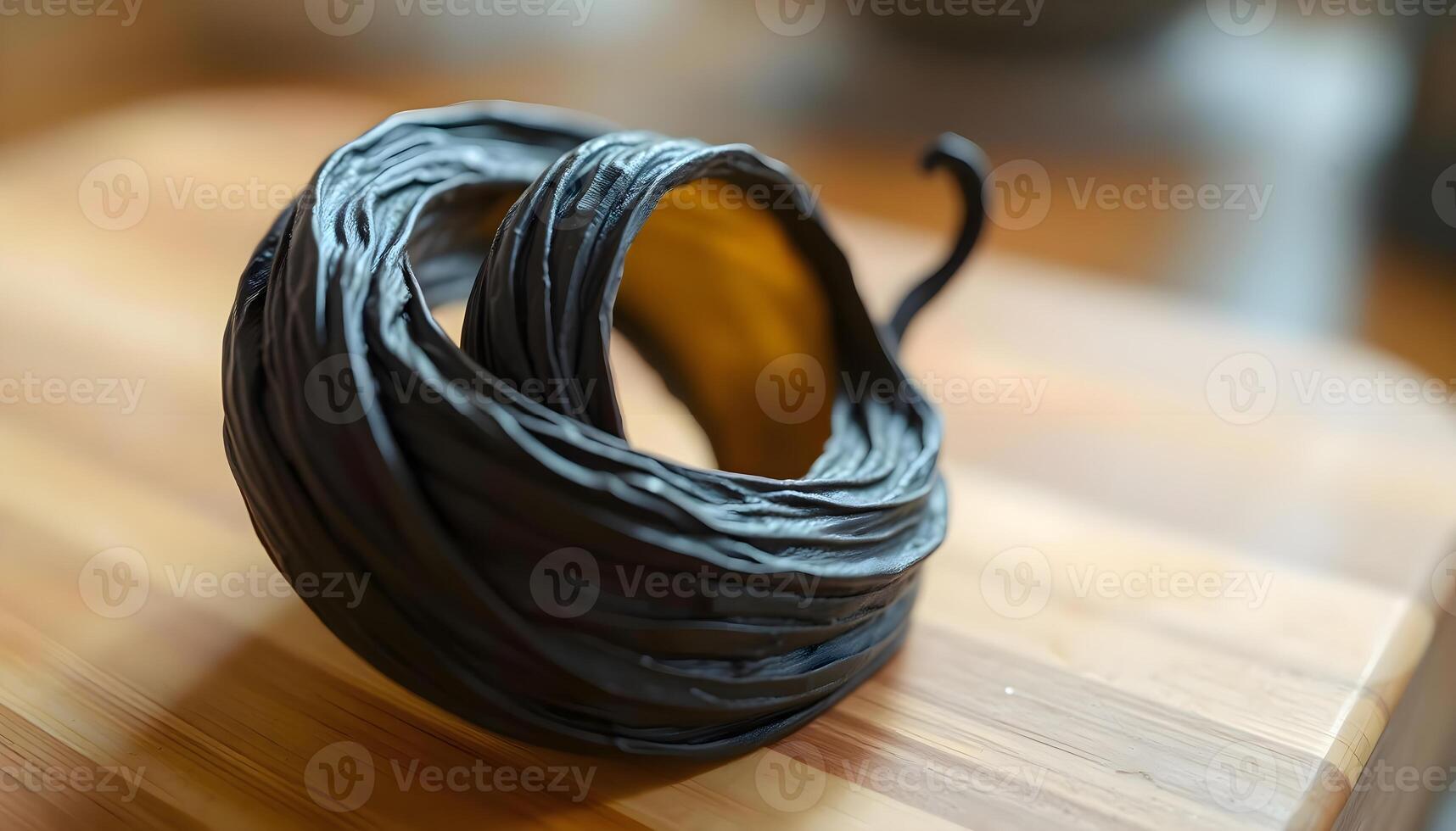 a close up of a wooden cutting board with a black object on it photo