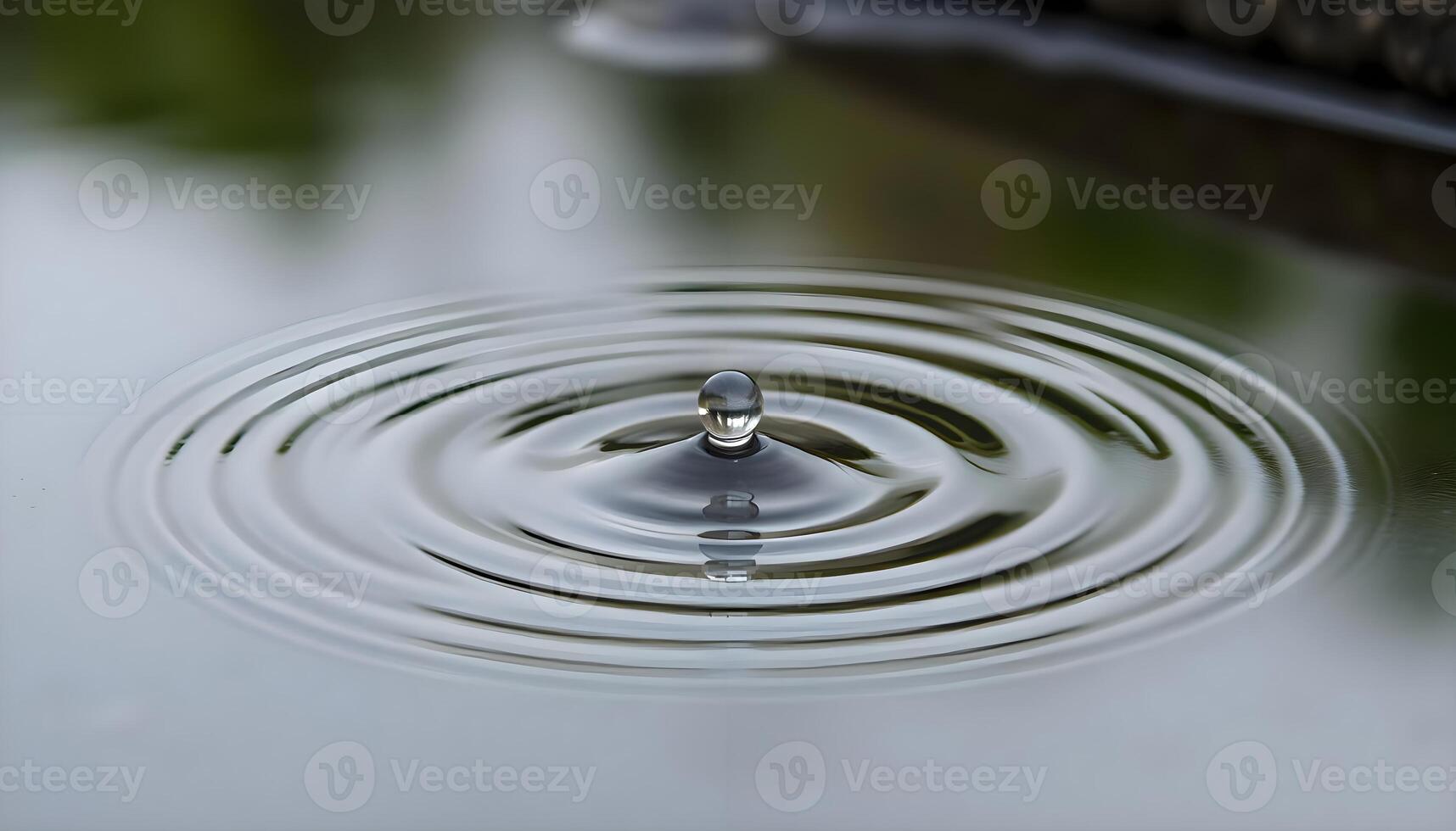 a close up of a water drop on a surface photo