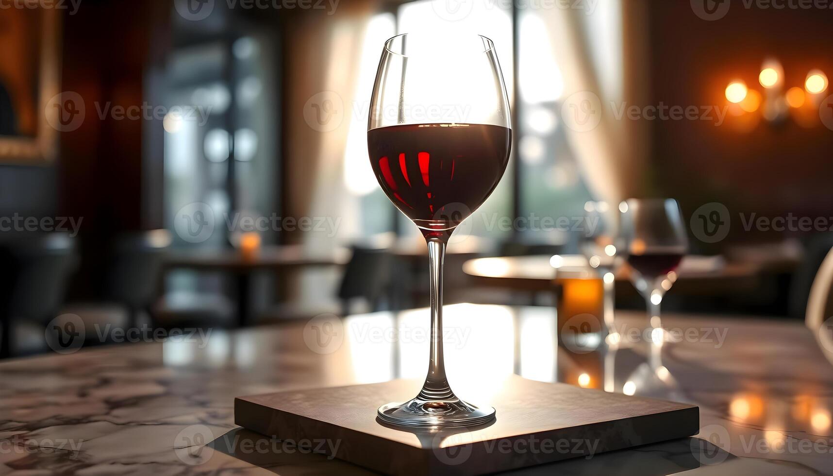 a glass of wine sitting on top of a table photo