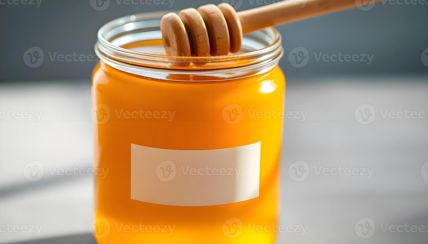 a jar of honey with a wooden stick sticking out of it photo