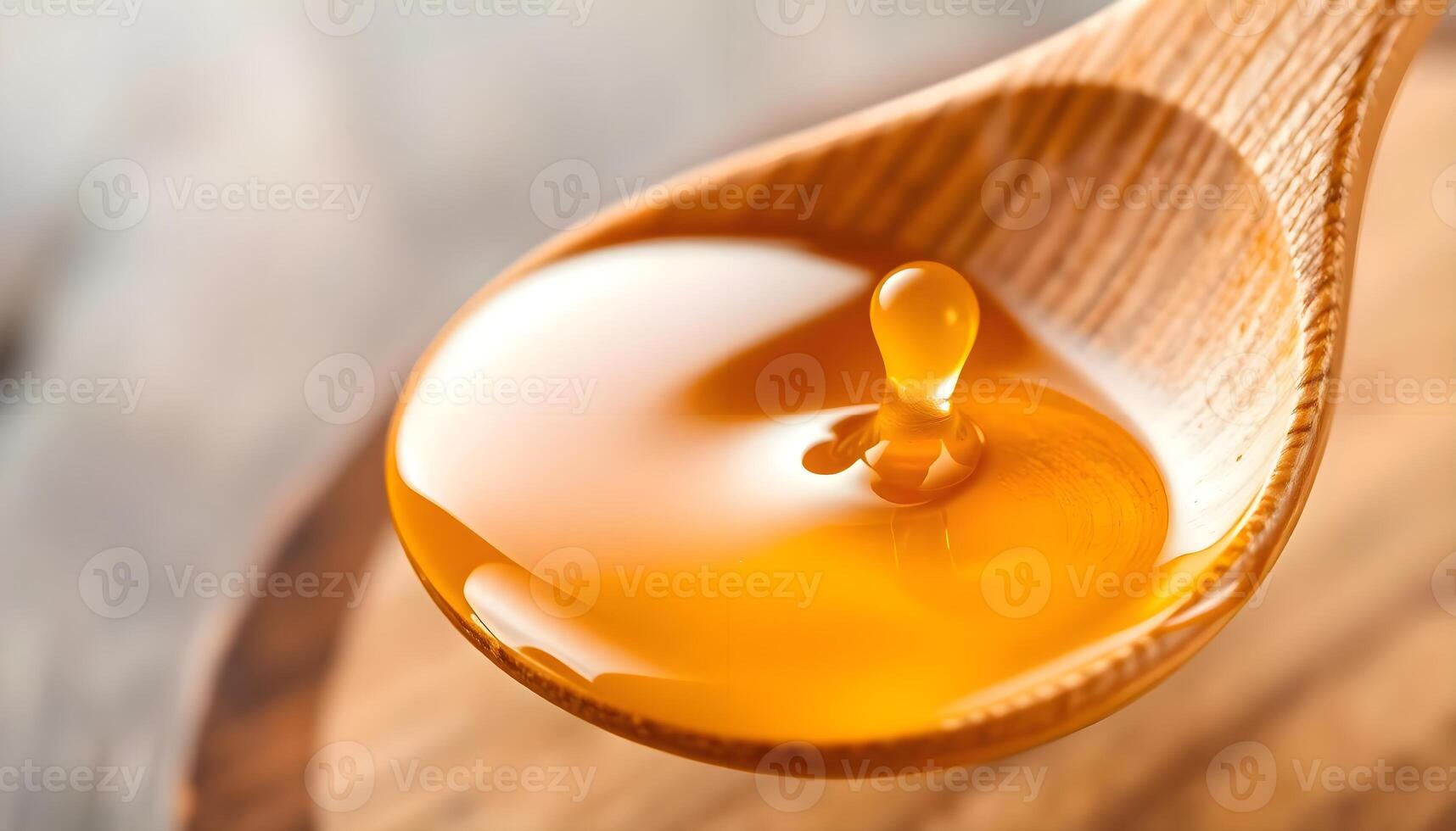 a spoon filled with liquid on top of a wooden table photo