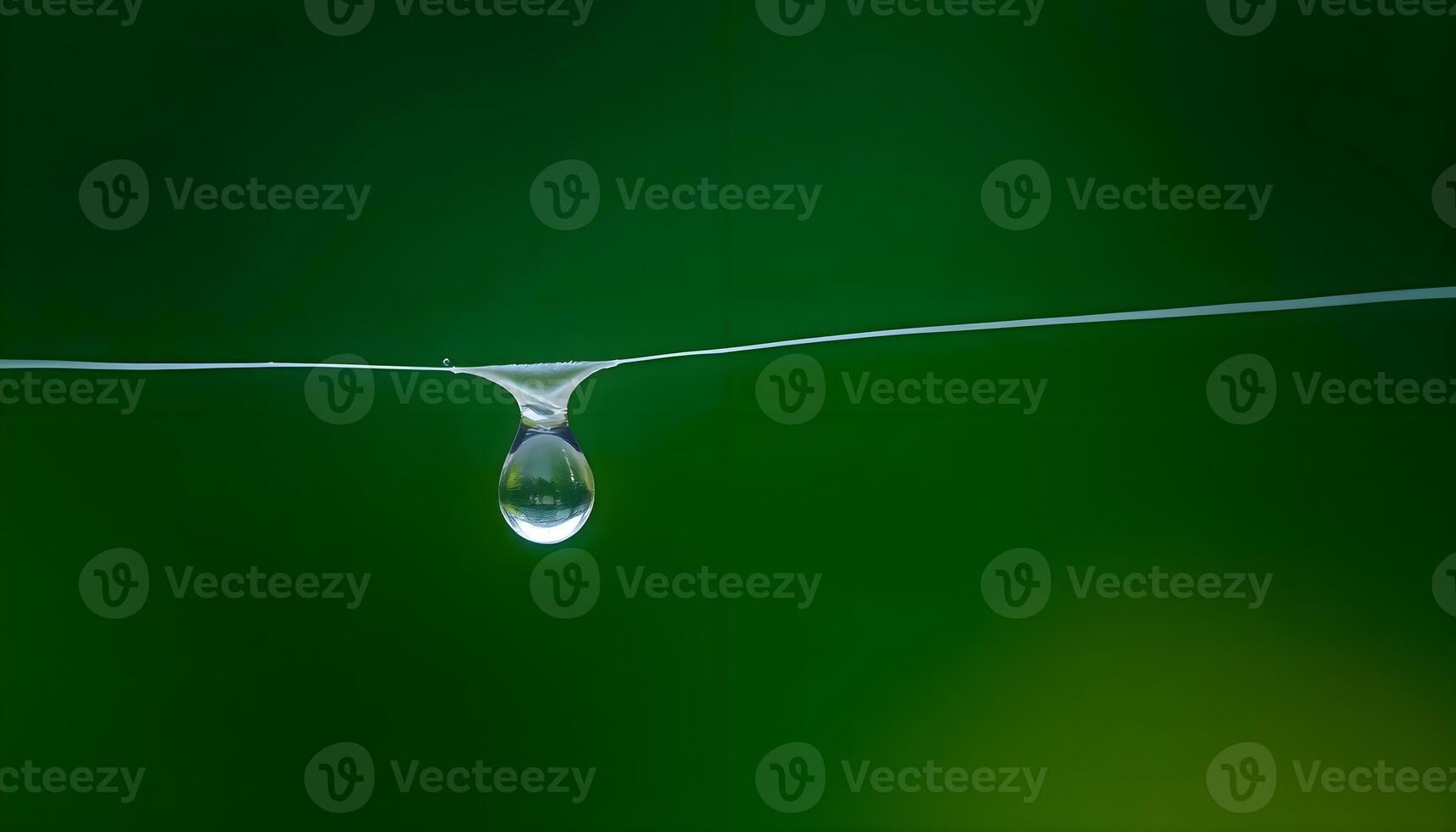 a drop of water hanging from a wire photo