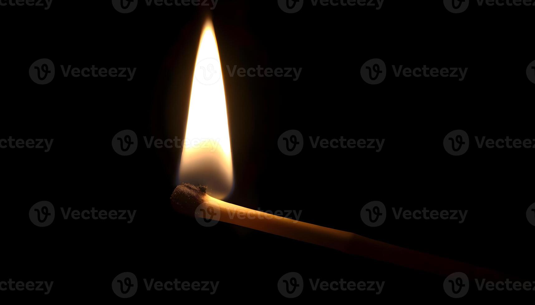 a lit matchstick in the dark with a lit match photo