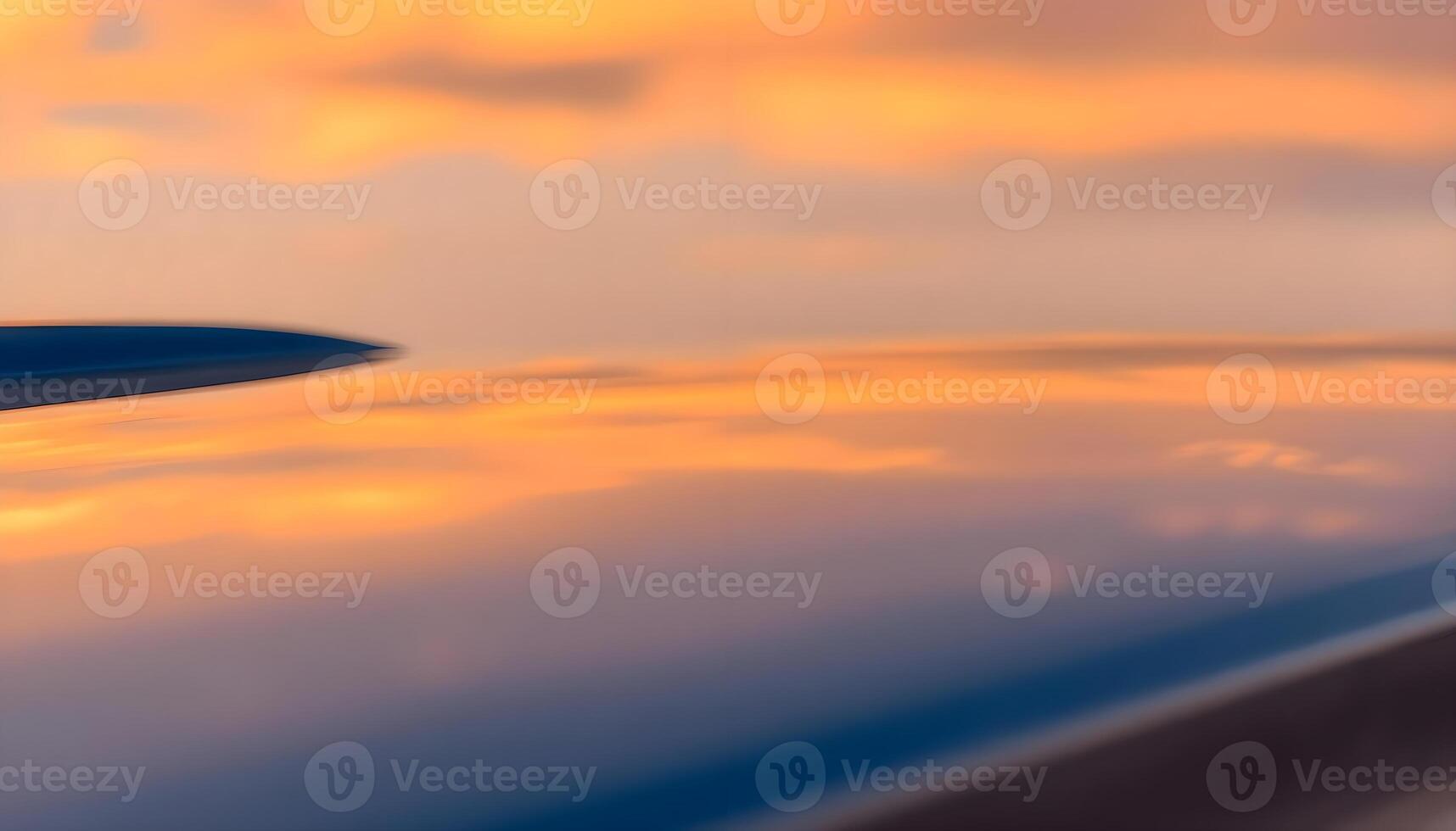 a view of the wing of an airplane at sunset photo