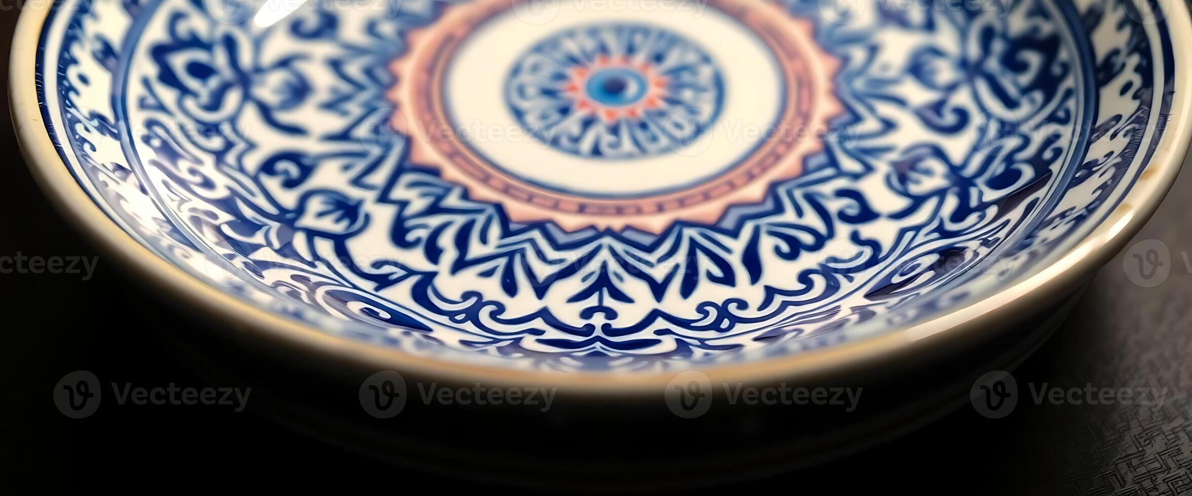 blue and white bowl sitting on top of a table photo