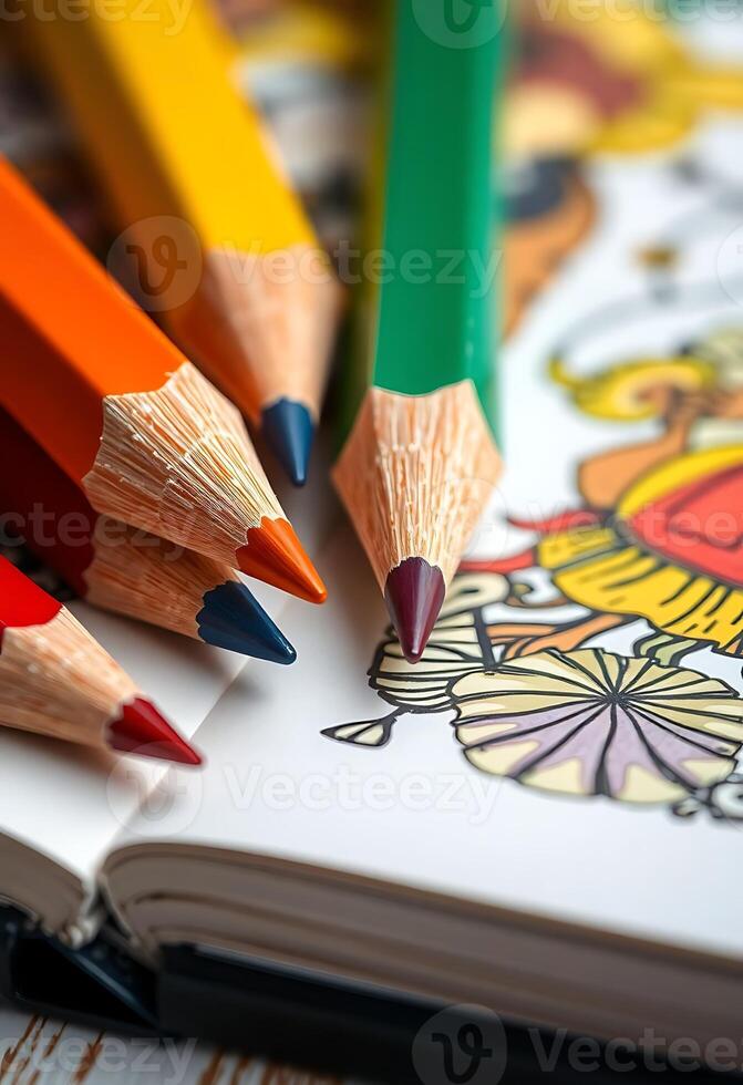 group of pencils sitting on top of a coloring book photo